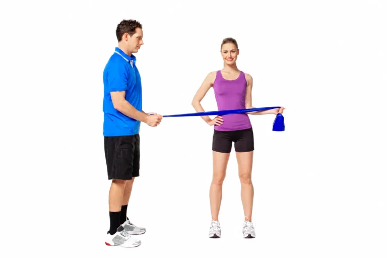 External shoulder rotation with a coach-held blue band. The video uses a green band; band colour alone does not specify a resistance prescription.