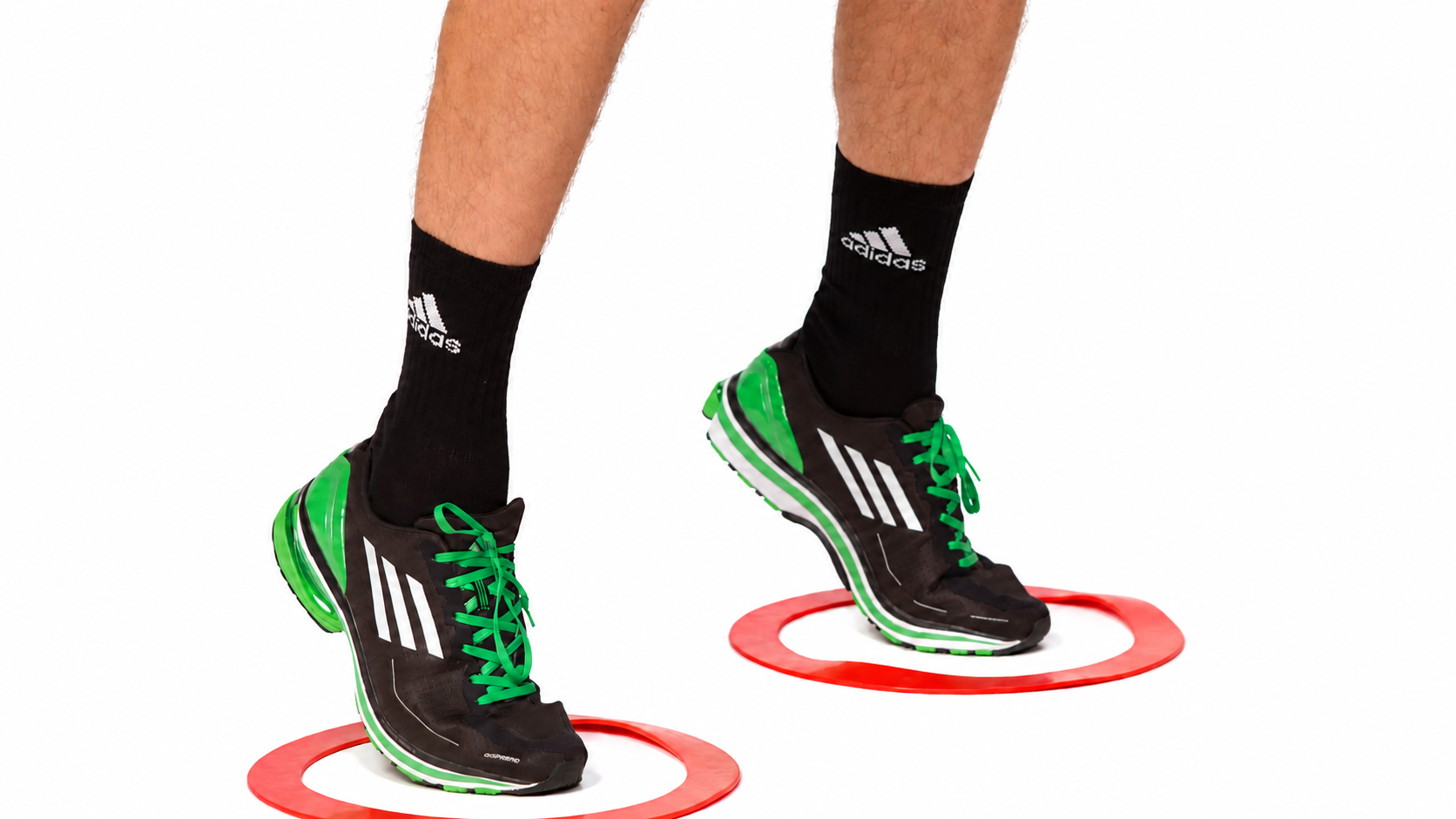 Two Shots & Ladder + Volley: Foot-position detail: one foot in each ring, with both heels raised.